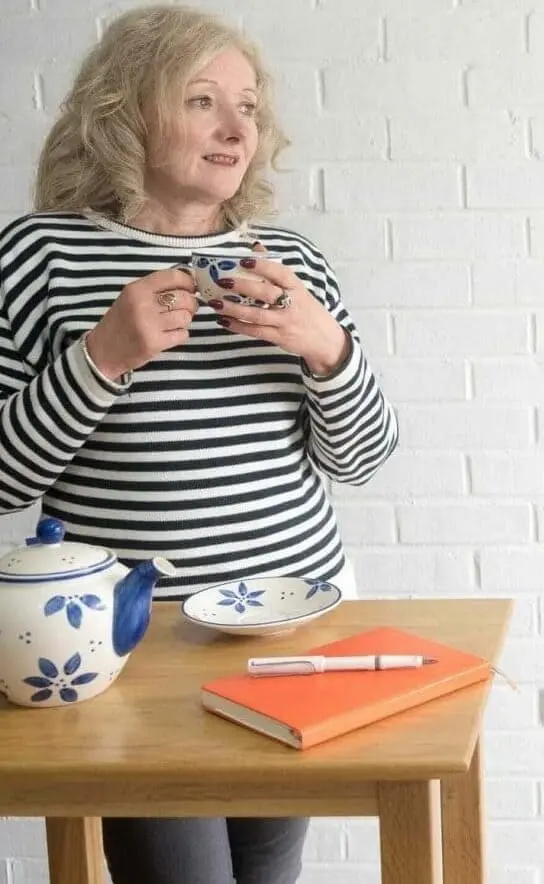 Linda Fox with tea and orange planner