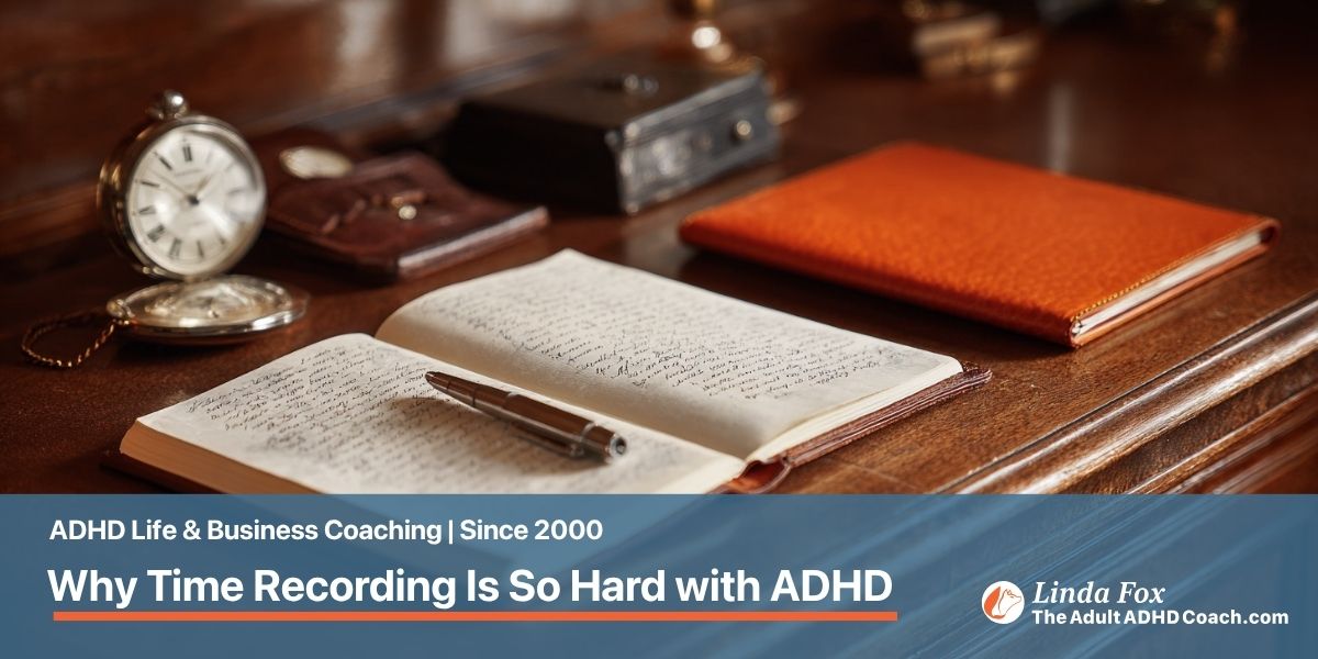 A solicitor's desk with a leather notebook, silver fountain pen, vintage pocket watch, and orange leather portfolio.