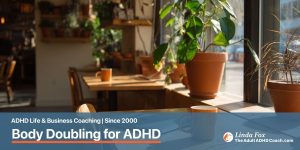 Blog post: Body Doubling for ADHD — a quiet sunlit coffee shop interior with two parallel workstations, representing the ambient presence that helps ADHD brains focus