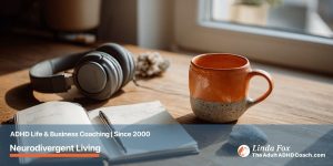 Blog post: Neurodivergent Living — a curated personal workspace with noise-cancelling headphones, a notebook, a mug, and a sensory fidget stone, representing a system built around how your brain actually works