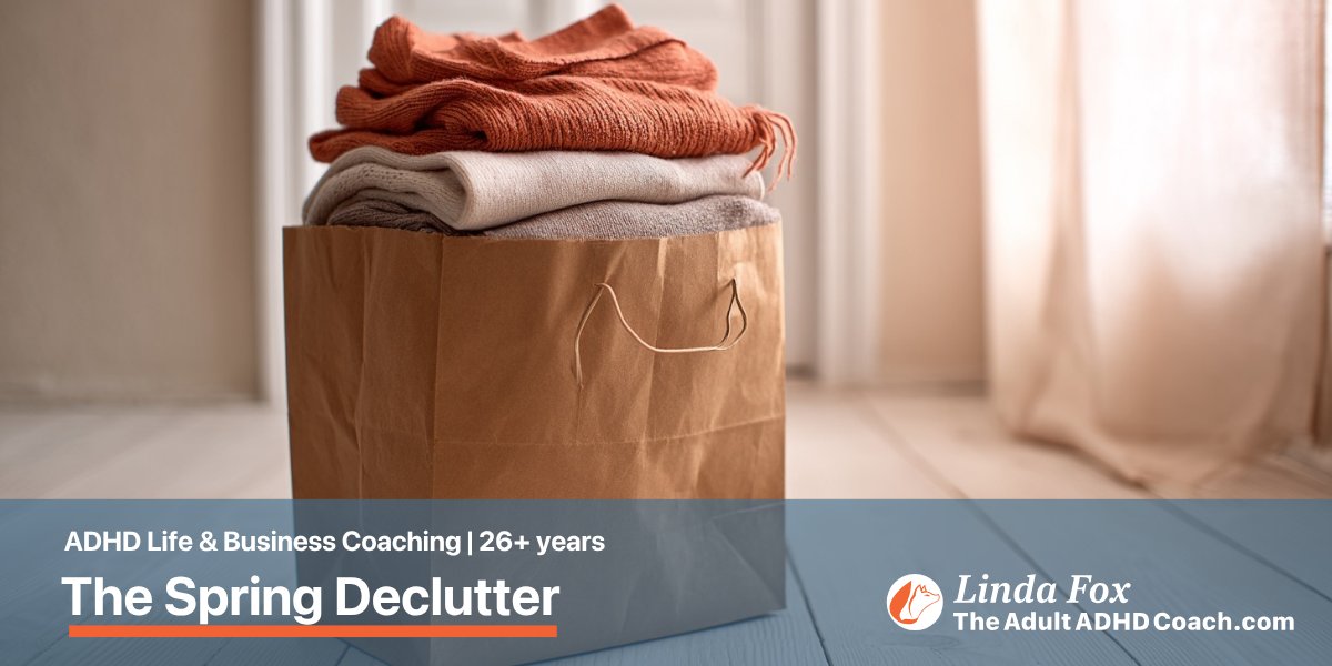Blog post: The Spring Declutter an ADHD Brain Actually Needs — a paper bag holding neatly folded clothes ready for donation, representing considered small letting-go
