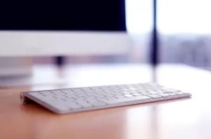 Smartphone and laptop on a workspace desk